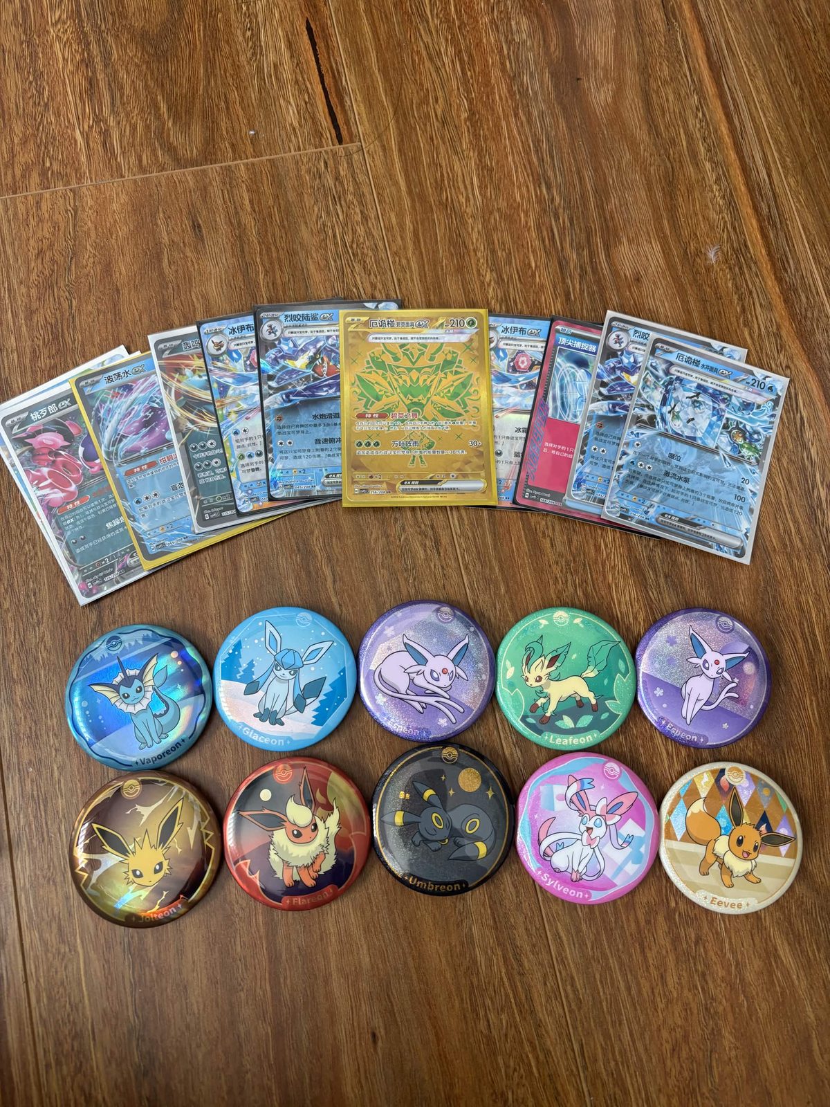 Pokémon cards and Eeveelution pin badges
